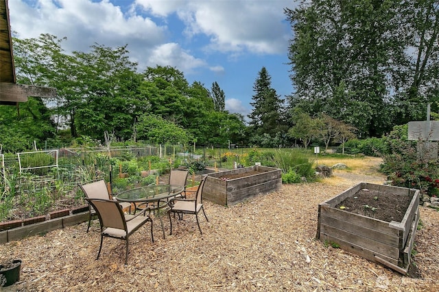 1902 Bigelow Ave N Unit 301, Seattle, WA 98109 - view of patio / terrace featuring a vegetable garden and view of wooded area