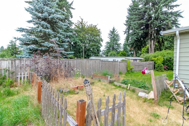 8715 Whitewood Loop SE, Yelm, WA 98597 - fenced backyard with a garden