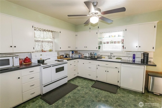 1107 S 4th St, Dayton, WA 99328 - kitchen featuring white appliances, dark flooring, plenty of natural light, and dark countertops