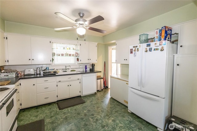 1107 S 4th St, Dayton, WA 99328 - kitchen with white appliances, dark floors, a ceiling fan, white cabinetry, and dark countertops
