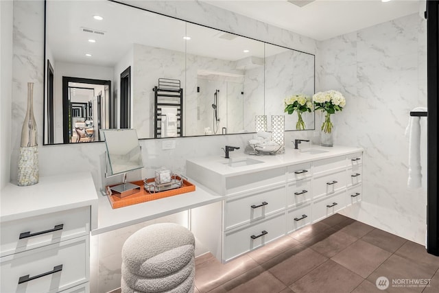 101 101st Ave SE Unit 201A, Bellevue, WA 98004 - full bath featuring tile walls, double vanity, a marble finish shower, recessed lighting, and a towel warming rack