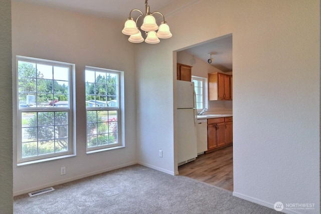 4018 144th Street Ct NW Unit 59, Gig Harbor, WA 98332 - unfurnished dining area featuring a chandelier, light colored carpet, and plenty of natural light