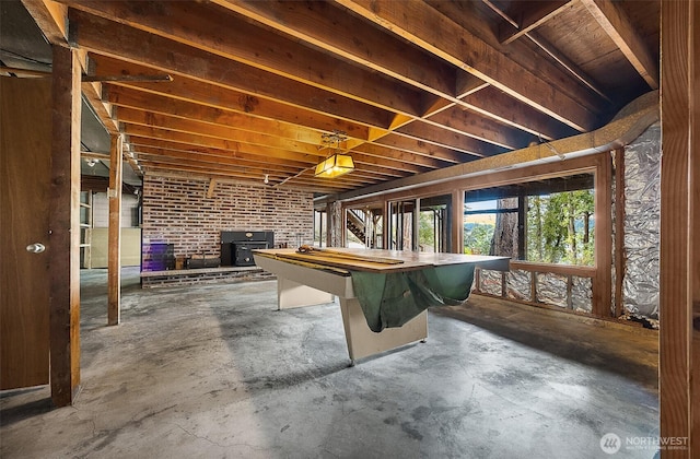 1711 E Lake Sammamish Pl SE, Sammamish, WA 98075 - game room featuring a wood stove and unfinished concrete floors