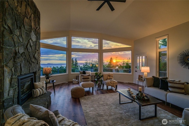 3995 Bay Ln, Anacortes, WA 98221 - living room with vaulted ceiling, wood finished floors, a fireplace, and ceiling fan