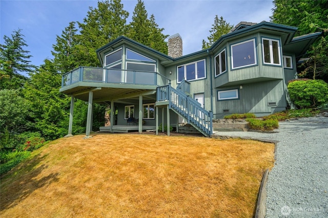 3995 Bay Ln, Anacortes, WA 98221 - back of property with a chimney, stairs, and a wooden deck