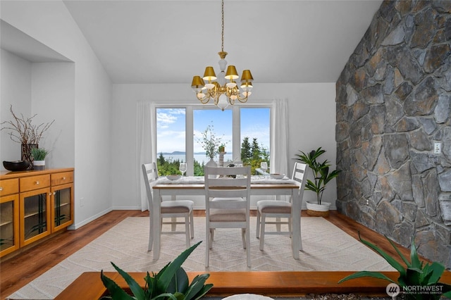 3995 Bay Ln, Anacortes, WA 98221 - dining room with a chandelier, wood finished floors, and lofted ceiling