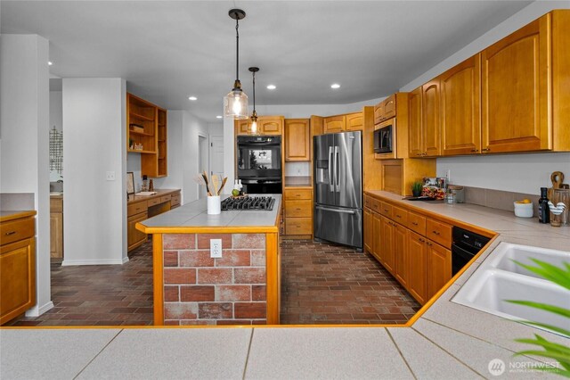 3995 Bay Ln, Anacortes, WA 98221 - kitchen featuring stainless steel appliances, brick flooring, tile countertops, recessed lighting, and decorative light fixtures