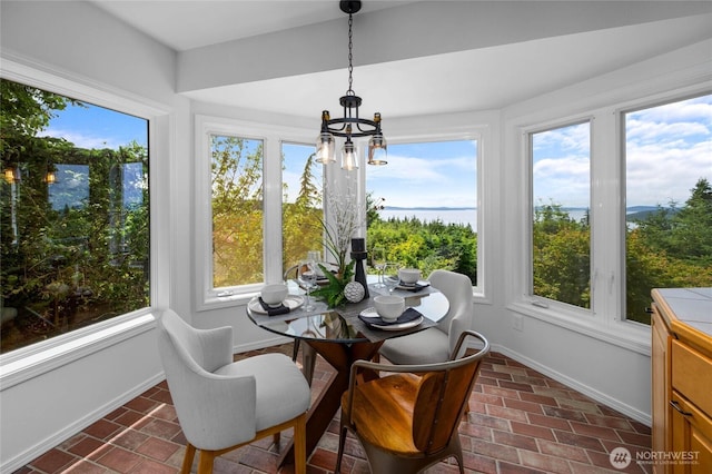 3995 Bay Ln, Anacortes, WA 98221 - sunroom / solarium featuring brick floors and a chandelier