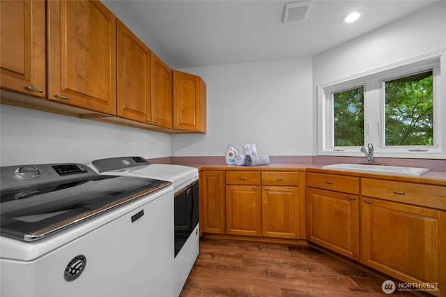 3995 Bay Ln, Anacortes, WA 98221 - laundry area featuring separate washer and dryer, dark wood finished floors, cabinet space, and recessed lighting