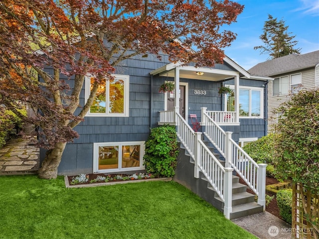 3833 24th Ave W, Seattle, WA 98199 - view of front of property featuring a front lawn, a porch, and stairway