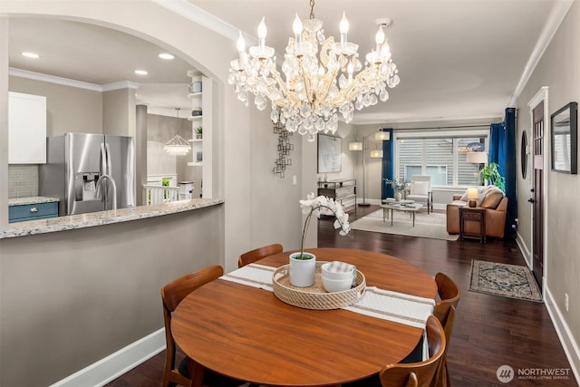 3833 24th Ave W, Seattle, WA 98199 - dining room featuring crown molding, arched walkways, a chandelier, dark wood-style flooring, and recessed lighting