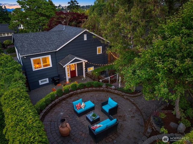 3833 24th Ave W, Seattle, WA 98199 - traditional-style house featuring a patio, roof with shingles, and an outdoor living space