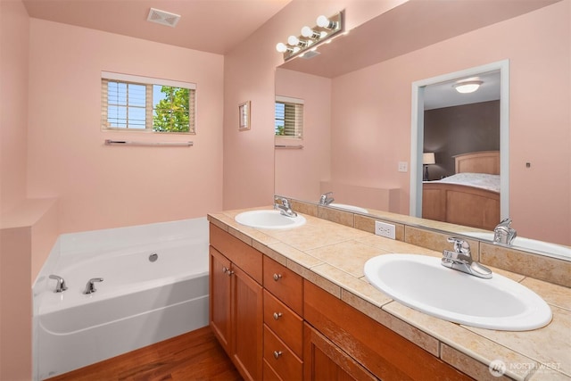 3610 147th Pl SE, Mill Creek, WA 98012 - ensuite bathroom featuring double vanity, a bath, and wood finished floors