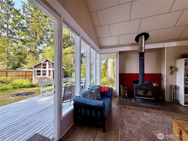 877 Mount Olympus Ave SE, Ocean Shores, WA 98569 - sunroom / solarium with wood finished floors, a wood stove, and vaulted ceiling