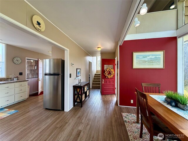 877 Mount Olympus Ave SE, Ocean Shores, WA 98569 - kitchen featuring freestanding refrigerator, wood finished floors, and white cabinetry