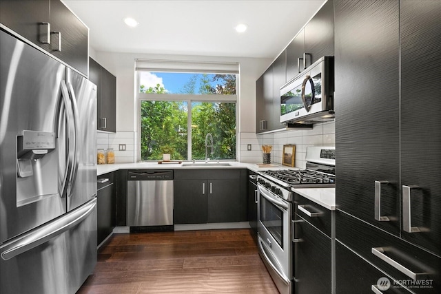 1110 Martin Luther King Jr Way S Unit A, Seattle, WA 98144 - kitchen featuring appliances with stainless steel finishes, light countertops, dark cabinetry, dark wood finished floors, and recessed lighting