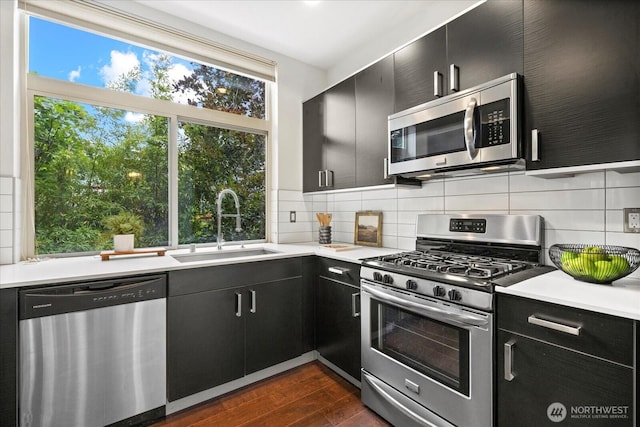 1110 Martin Luther King Jr Way S Unit A, Seattle, WA 98144 - kitchen with appliances with stainless steel finishes, dark cabinets, dark wood finished floors, and light countertops