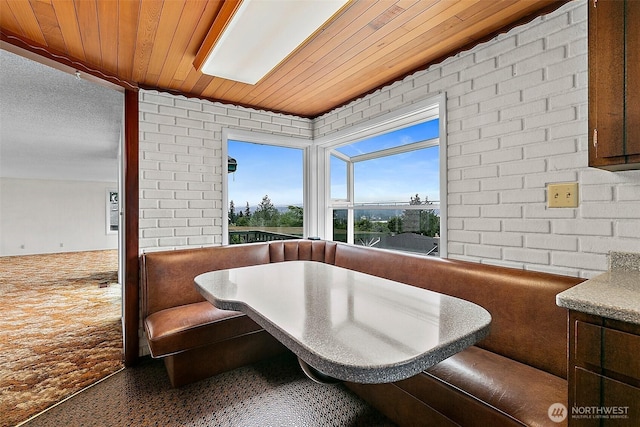 29432 59th Ave S, Auburn, WA 98001 - bathroom featuring wooden ceiling, speckled floor, and brick wall