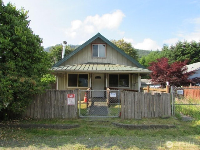 725 W Main, Morton, WA 98356 - bungalow-style house featuring a porch, a fenced front yard, board and batten siding, and a gate