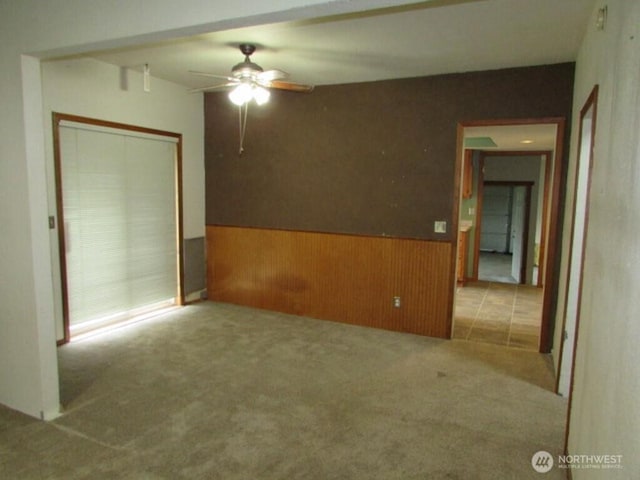 725 W Main, Morton, WA 98356 - carpeted spare room with a ceiling fan, a wainscoted wall, and wooden walls