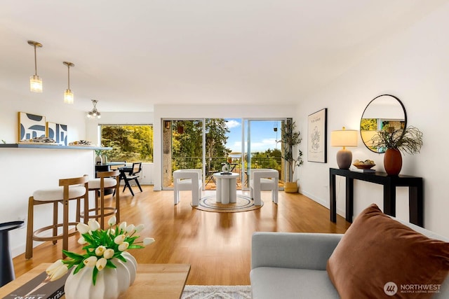 11515 Greenwood Ave N Unit C, Seattle, WA 98133 - living area featuring wood finished floors and a chandelier
