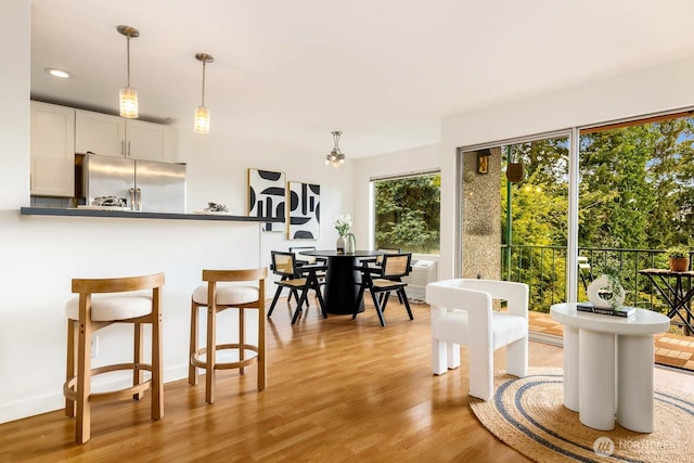 11515 Greenwood Ave N Unit C, Seattle, WA 98133 - dining room with light wood finished floors and recessed lighting