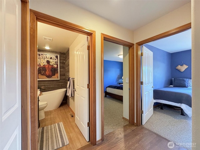206 Buckhorn, Sequim, WA 98382 - full bath featuring connected bathroom, a freestanding bath, and wood finished floors