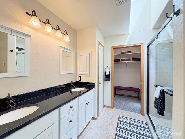 206 Buckhorn, Sequim, WA 98382 - bathroom with double vanity, a spacious closet, and a shower stall