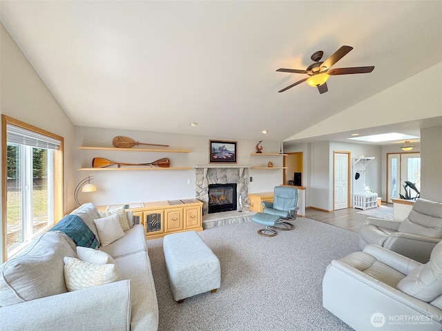 206 Buckhorn, Sequim, WA 98382 - carpeted living room featuring lofted ceiling, a ceiling fan, and a stone fireplace