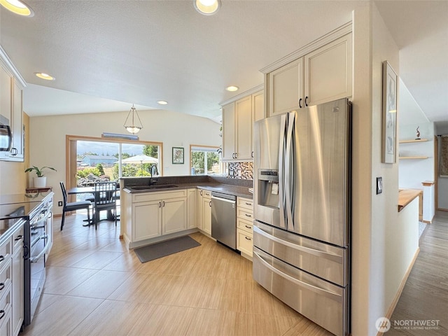 206 Buckhorn, Sequim, WA 98382 - kitchen with appliances with stainless steel finishes, a peninsula, dark countertops, recessed lighting, and decorative light fixtures