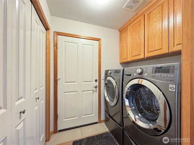 206 Buckhorn, Sequim, WA 98382 - washroom with washer and dryer, cabinet space, and light tile patterned floors