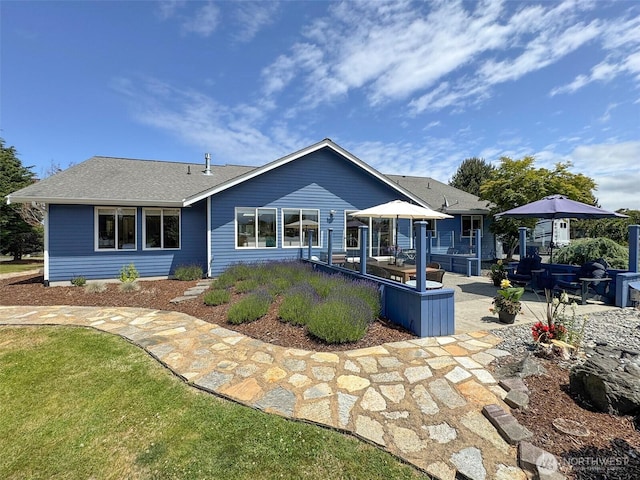 206 Buckhorn, Sequim, WA 98382 - back of house featuring a patio area and roof with shingles