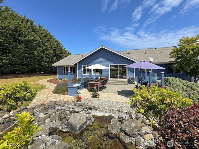 206 Buckhorn, Sequim, WA 98382 - back of house featuring a patio area and a shingled roof