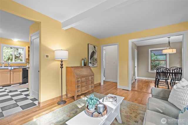 13527 23rd Ave NE, Seattle, WA 98125 - living room featuring plenty of natural light, light wood finished floors, and beam ceiling