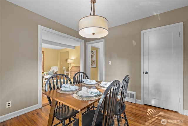 13527 23rd Ave NE, Seattle, WA 98125 - dining space with hardwood / wood-style flooring and baseboards