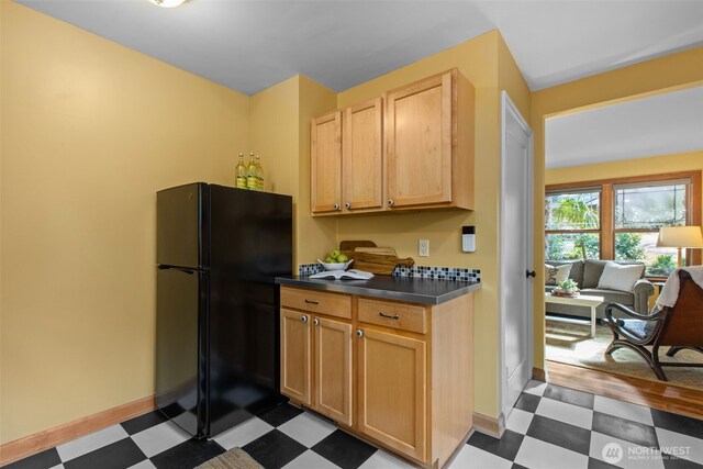 13527 23rd Ave NE, Seattle, WA 98125 - kitchen featuring freestanding refrigerator, dark floors, dark countertops, and light brown cabinets