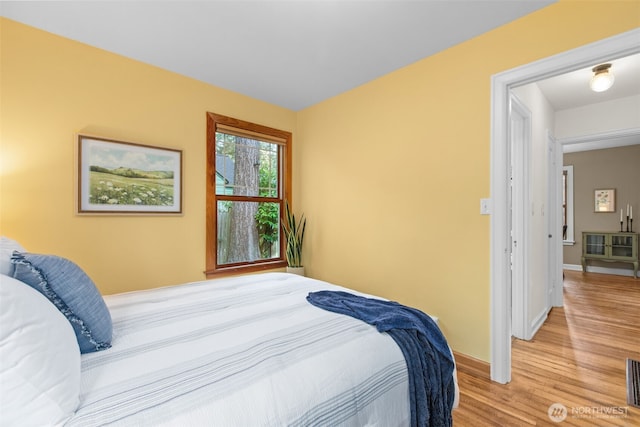 13527 23rd Ave NE, Seattle, WA 98125 - bedroom featuring light wood-type flooring and baseboards
