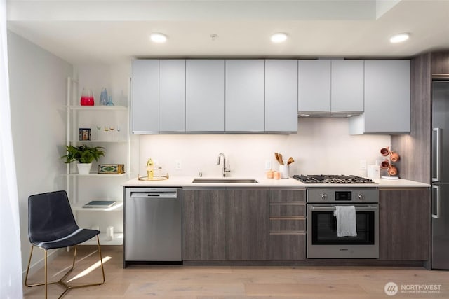 800 Columbia St Unit 708, Seattle, WA 98104 - kitchen with stainless steel appliances, light countertops, open shelves, recessed lighting, and modern cabinets