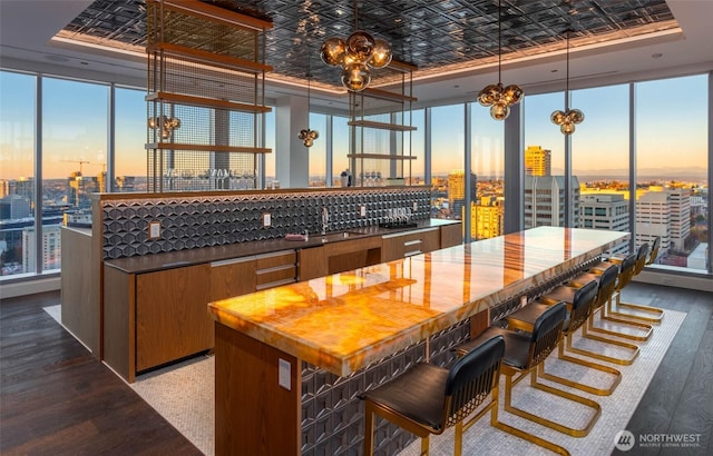 800 Columbia St Unit 708, Seattle, WA 98104 - kitchen with a chandelier, a city view, an ornate ceiling, floor to ceiling windows, and brown cabinets