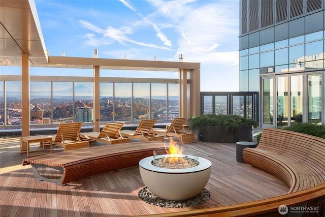 800 Columbia St Unit 708, Seattle, WA 98104 - wooden deck featuring an outdoor fire pit