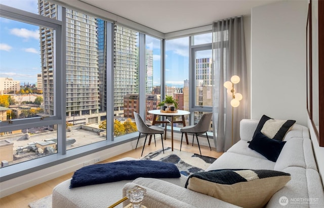 800 Columbia St Unit 1708, Seattle, WA 98104 - sunroom featuring a city view, wood finished floors, and floor to ceiling windows