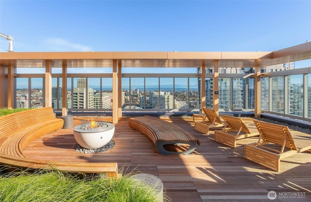 800 Columbia St Unit 1708, Seattle, WA 98104 - wooden deck featuring an outdoor fire pit and a view of city