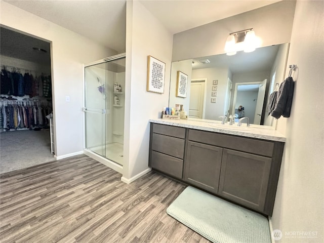 9151 Viola St SE, Tumwater, WA 98501 - full bath featuring wood finished floors, a shower stall, vanity, and a spacious closet