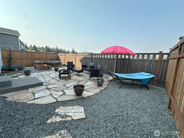 9151 Viola St SE, Tumwater, WA 98501 - fenced backyard with an outdoor fire pit and a patio area