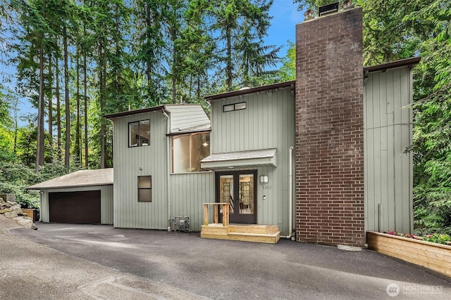 1820 NE 177th St, Shoreline, WA 98155 - view of front of home featuring french doors, a chimney, and driveway