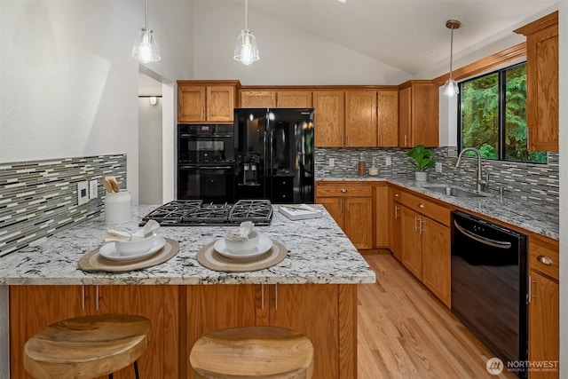 1820 NE 177th St, Shoreline, WA 98155 - kitchen featuring black appliances, vaulted ceiling, light wood-style floors, brown cabinetry, and decorative backsplash