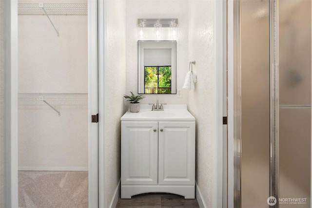 1820 NE 177th St, Shoreline, WA 98155 - full bath with a walk in closet, vanity, a stall shower, and a textured wall