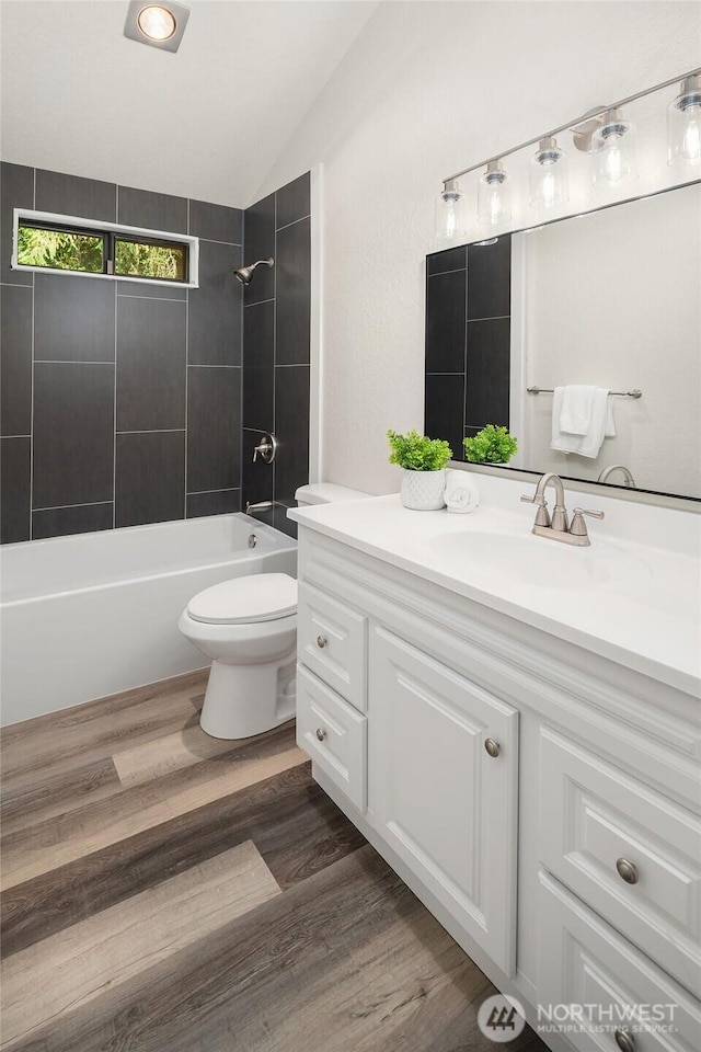 1820 NE 177th St, Shoreline, WA 98155 - full bathroom featuring vanity, vaulted ceiling, bathing tub / shower combination, and wood finished floors