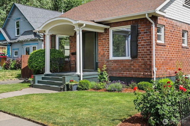 12 Newell St, Walla Walla, WA 99362 - view of front facade with a front yard, a shingled roof, and brick siding