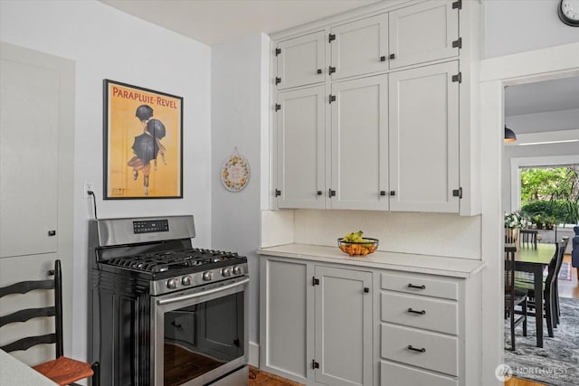 12 Newell St, Walla Walla, WA 99362 - kitchen with gas stove, light countertops, and white cabinets